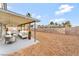 Landscaped backyard featuring a covered patio with lounge seating and barbecue at 5815 Christchurch Ave, Las Vegas, NV 89110