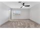 Bedroom featuring neutral carpet, white walls, ceiling fan, and a window with white shutters at 5815 Christchurch Ave, Las Vegas, NV 89110