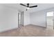 Bedroom featuring neutral carpet, white walls, ceiling fan, and closet at 5815 Christchurch Ave, Las Vegas, NV 89110