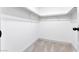 Walk-in closet featuring carpet flooring, white walls, and shelving at 5815 Christchurch Ave, Las Vegas, NV 89110