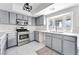 Updated kitchen featuring stainless steel appliances, gray cabinets, and quartz countertops at 5815 Christchurch Ave, Las Vegas, NV 89110