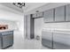 Spacious kitchen with stainless steel appliances, gray cabinets, and eat-in island at 5815 Christchurch Ave, Las Vegas, NV 89110