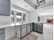 Bright kitchen featuring stainless steel sink, gray cabinets, and ample countertop space at 5815 Christchurch Ave, Las Vegas, NV 89110