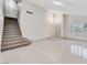 Open living space featuring a staircase, vaulted ceilings, and modern light fixtures at 5815 Christchurch Ave, Las Vegas, NV 89110