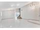 Open and bright living room with a grand staircase and contemporary lighting at 5815 Christchurch Ave, Las Vegas, NV 89110