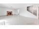 Bright living room featuring a brick fireplace, staircase, and marble floors at 5815 Christchurch Ave, Las Vegas, NV 89110