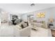 Bright living room with stylish furnishings, neutral tones, and sliding glass door to backyard at 5815 Christchurch Ave, Las Vegas, NV 89110