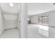 Open living room featuring a closet, tile flooring, and sliding glass doors to backyard at 5815 Christchurch Ave, Las Vegas, NV 89110