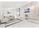 Open-concept living room boasts high ceilings, elegant lighting, and neutral decor at 5815 Christchurch Ave, Las Vegas, NV 89110