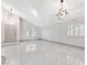 Bright living room shows soaring ceiling, shuttered windows, and contemporary light fixture at 5815 Christchurch Ave, Las Vegas, NV 89110