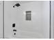 White tiled shower with black fixtures at 5815 Christchurch Ave, Las Vegas, NV 89110