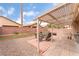 Backyard patio featuring covered area with seating and drought tolerant landscaping at 5991 Saddle Horse Ave, Las Vegas, NV 89122