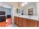 Bathroom view with double vanity, wood floors and view to the main bedroom at 5991 Saddle Horse Ave, Las Vegas, NV 89122