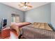 Bedroom featuring two beds, wood floors and a ceiling fan at 5991 Saddle Horse Ave, Las Vegas, NV 89122
