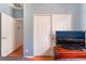 Bedroom with wood floors and TV on dresser with double closets in background at 5991 Saddle Horse Ave, Las Vegas, NV 89122