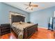 Stylish bedroom with blue walls, a ceiling fan, a large bed, and laminate wood-look flooring at 5991 Saddle Horse Ave, Las Vegas, NV 89122