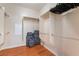 Spacious walk-in closet with wood floor, multiple rods for hanging clothes and luggage at 5991 Saddle Horse Ave, Las Vegas, NV 89122