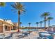 Relaxing community pool with palm trees and lounge chairs, offering a resort-style experience at 5991 Saddle Horse Ave, Las Vegas, NV 89122
