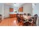 Sunny dining area with wood floors, charming chairs, and a view of the outdoor scenery at 5991 Saddle Horse Ave, Las Vegas, NV 89122