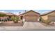 Charming single-story home featuring a two-car garage, well-manicured landscaping, and a cozy front porch at 5991 Saddle Horse Ave, Las Vegas, NV 89122