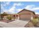 Inviting single-story home featuring a two-car garage, desert landscaping, and a spacious driveway at 5991 Saddle Horse Ave, Las Vegas, NV 89122