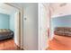 View of hallway leading to bedroom and living room featuring hardwood floors and neutral paint at 5991 Saddle Horse Ave, Las Vegas, NV 89122