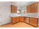 Well-lit kitchen featuring stainless steel dishwasher, ample cabinet space, and laminate wood-look flooring at 5991 Saddle Horse Ave, Las Vegas, NV 89122