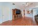 Inviting living room featuring wood floors, an entertainment center, and a door to the outside at 5991 Saddle Horse Ave, Las Vegas, NV 89122