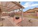 Spacious covered patio with seating, fire pit, and lush landscaping, great for outdoor living at 5991 Saddle Horse Ave, Las Vegas, NV 89122