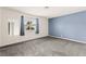 Spacious bedroom with neutral carpet, a window with blinds, and light blue accent wall at 6155 W Twain Ave, Las Vegas, NV 89103