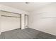 Empty bedroom features neutral carpet, closet, and access to the next room at 6155 W Twain Ave, Las Vegas, NV 89103
