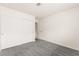 A cozy bedroom with neutral carpet, sliding door closet, and a doorway to another room at 6155 W Twain Ave, Las Vegas, NV 89103