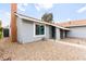 Low maintenance front yard with secure front entry gate and a well-maintained exterior at 6155 W Twain Ave, Las Vegas, NV 89103