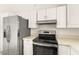 Modern kitchen with stainless steel refrigerator and black range at 6155 W Twain Ave, Las Vegas, NV 89103