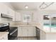 Modern kitchen with stainless steel appliances and view of the backyard pool at 6155 W Twain Ave, Las Vegas, NV 89103