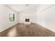 Bright living room features a fireplace and wood flooring at 6155 W Twain Ave, Las Vegas, NV 89103