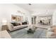 Open-concept living room with stylish furnishings and a view into the dining area and kitchen at 6155 W Twain Ave, Las Vegas, NV 89103