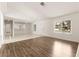 Bright living room features wood flooring and a view of the front yard at 6155 W Twain Ave, Las Vegas, NV 89103
