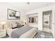 This virtually staged main bedroom is designed with soft textiles and an open closet space at 6155 W Twain Ave, Las Vegas, NV 89103