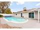 Backyard pool with access to the home, patio, and bordered by hardscape and a fence at 6155 W Twain Ave, Las Vegas, NV 89103