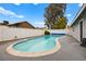 Inviting backyard pool with a spacious concrete deck, enclosed by a white brick fence for privacy at 6155 W Twain Ave, Las Vegas, NV 89103