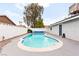 Backyard pool with a covered patio, landscaping, and complete privacy wall at 6155 W Twain Ave, Las Vegas, NV 89103