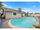 Backyard pool with access to the home, patio, and bordered by hardscape and a fence at 6155 W Twain Ave, Las Vegas, NV 89103