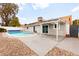 Backyard pool with lounge area, surrounded by a wall, rocks, and convenient access to the home at 6155 W Twain Ave, Las Vegas, NV 89103