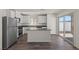 Modern kitchen featuring stainless steel appliances, dark countertops and wood grain vinyl flooring at 6246 Blood Lily Ave, Las Vegas, NV 89122