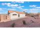 Spacious backyard featuring a covered patio and low-maintenance desert landscaping with a walled perimeter at 629 Majestic Sky Dr, North Las Vegas, NV 89031