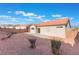 Backyard featuring a patio, rock landscaping, and a block wall at 629 Majestic Sky Dr, North Las Vegas, NV 89031