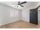 Bright bedroom featuring wood-look floors, ceiling fan, and window at 629 Majestic Sky Dr, North Las Vegas, NV 89031
