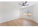 Bright bedroom with a ceiling fan, a window, and light wood-look flooring at 629 Majestic Sky Dr, North Las Vegas, NV 89031