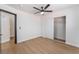 Bedroom featuring wood-look floors, ceiling fan, closet, and an interior door at 629 Majestic Sky Dr, North Las Vegas, NV 89031